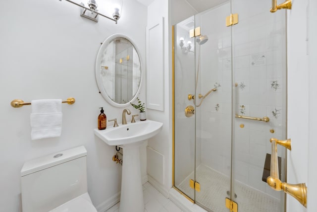 25 W 54th St Unit 8F, New York City, NY 10019 - bathroom with toilet, a stall shower, and tile patterned floors