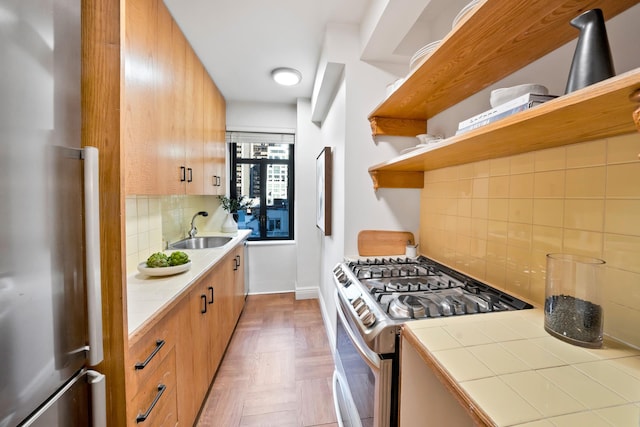 25 W 54th St Unit 8F, New York City, NY 10019 - kitchen with stainless steel appliances, backsplash, a sink, open shelves, and tile counters