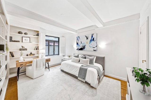 25 W 54th St Unit 8F, New York City, NY 10019 - bedroom featuring beamed ceiling, wood finished floors, and baseboards
