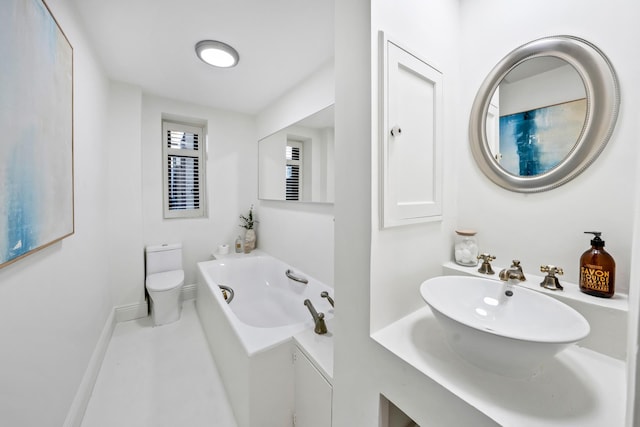25 W 54th St Unit 8F, New York City, NY 10019 - bathroom with toilet, a tub with jets, baseboards, and a sink