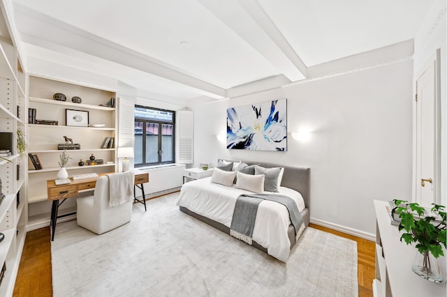 25 W 54th St Unit 8F, New York City, NY 10019 - bedroom with wood finished floors, beam ceiling, and baseboards