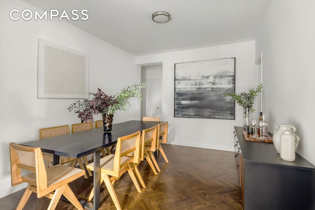 dining space with crown molding and baseboards