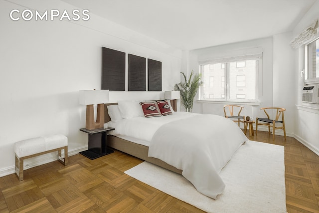bedroom with cooling unit and baseboards