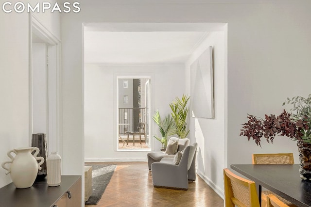 living area featuring ornamental molding and parquet floors