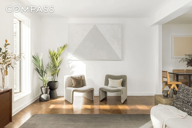 interior space featuring baseboards and crown molding