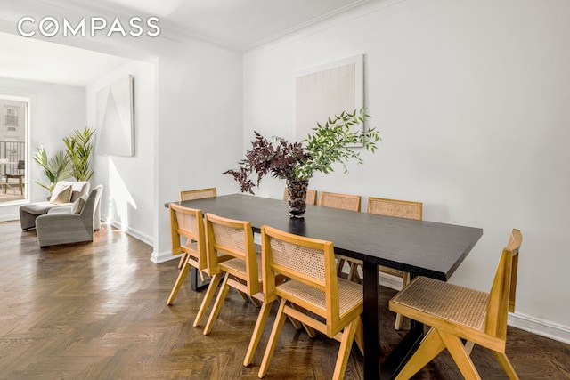 dining room with baseboards and ornamental molding
