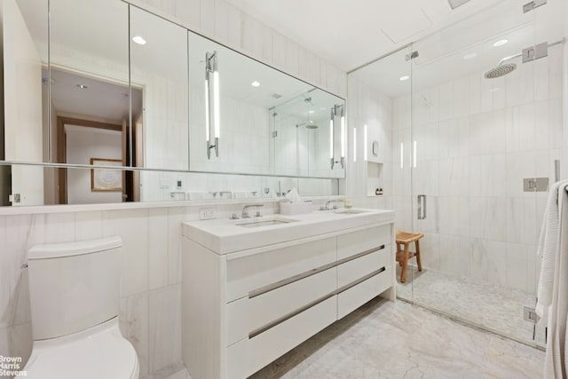 bathroom with a shower with shower door and tile walls