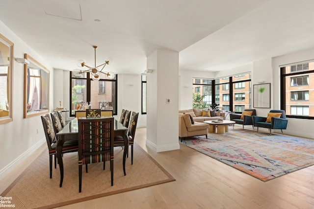 dining area featuring light hardwood / wood-style flooring and a chandelier