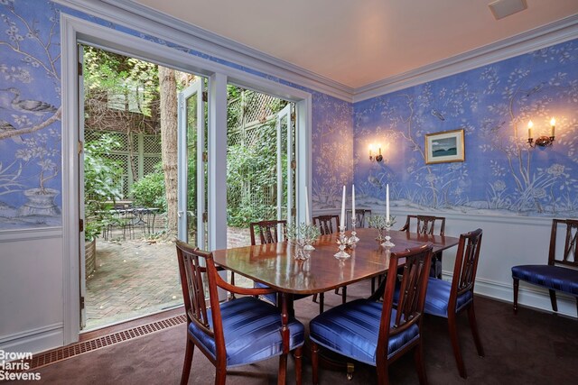 sitting room with crown molding, dark hardwood / wood-style floors, and a chandelier