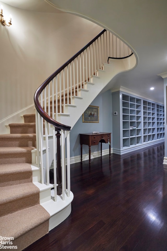 staircase with baseboards and wood finished floors