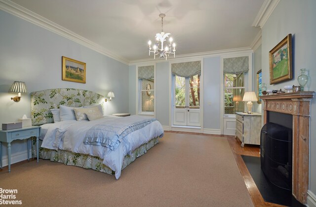 bedroom with multiple windows, ornamental molding, and an inviting chandelier