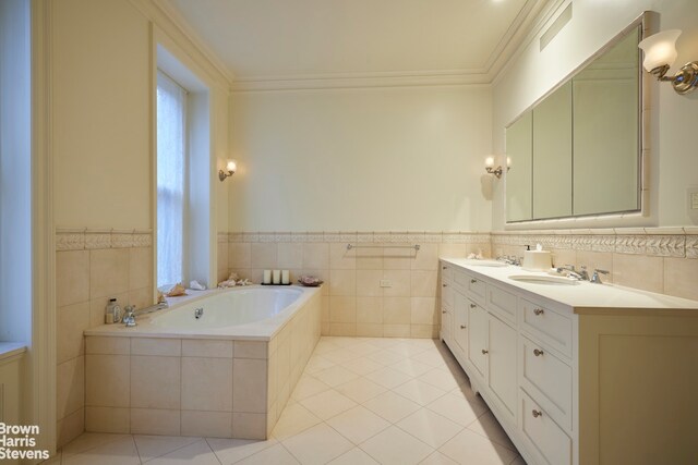 full bathroom featuring tile patterned floors, toilet, tile walls, vanity, and enclosed tub / shower combo