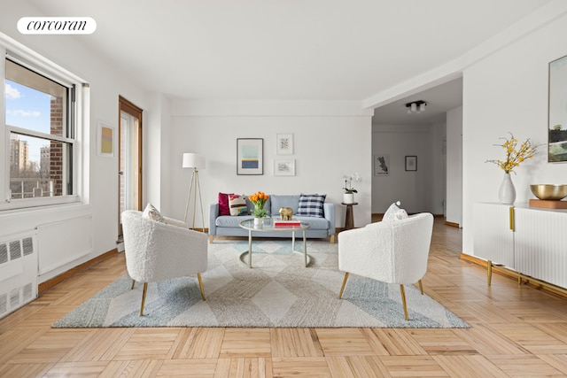 living room featuring light parquet flooring and radiator heating unit