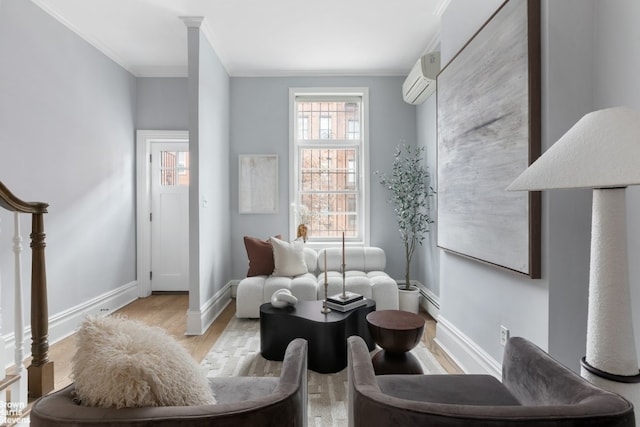 sitting room with ornamental molding, a wall unit AC, and light wood-type flooring