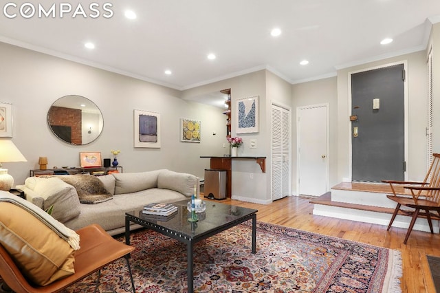 living room featuring ornamental molding and light hardwood / wood-style flooring