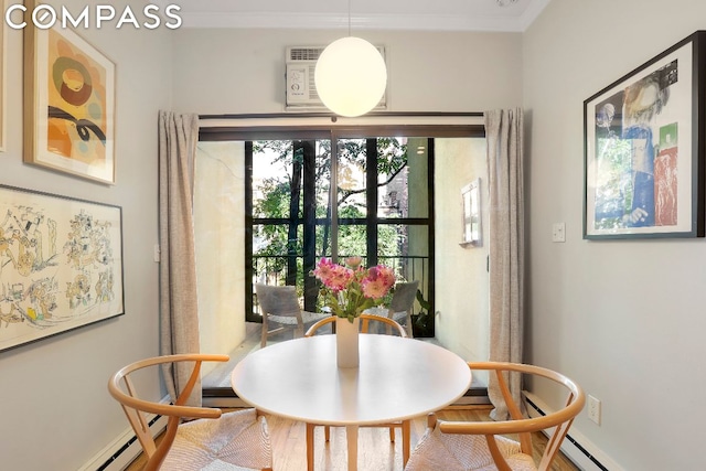 dining area featuring baseboard heating and ornamental molding