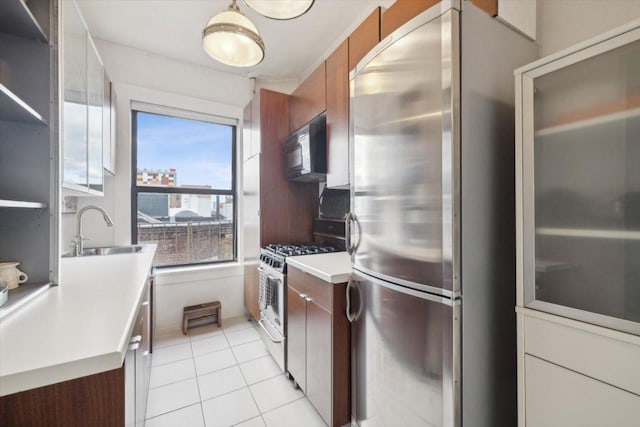 kitchen featuring sink, stainless steel appliances, and light tile patterned flooring