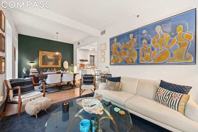 living room featuring hardwood / wood-style floors and beamed ceiling