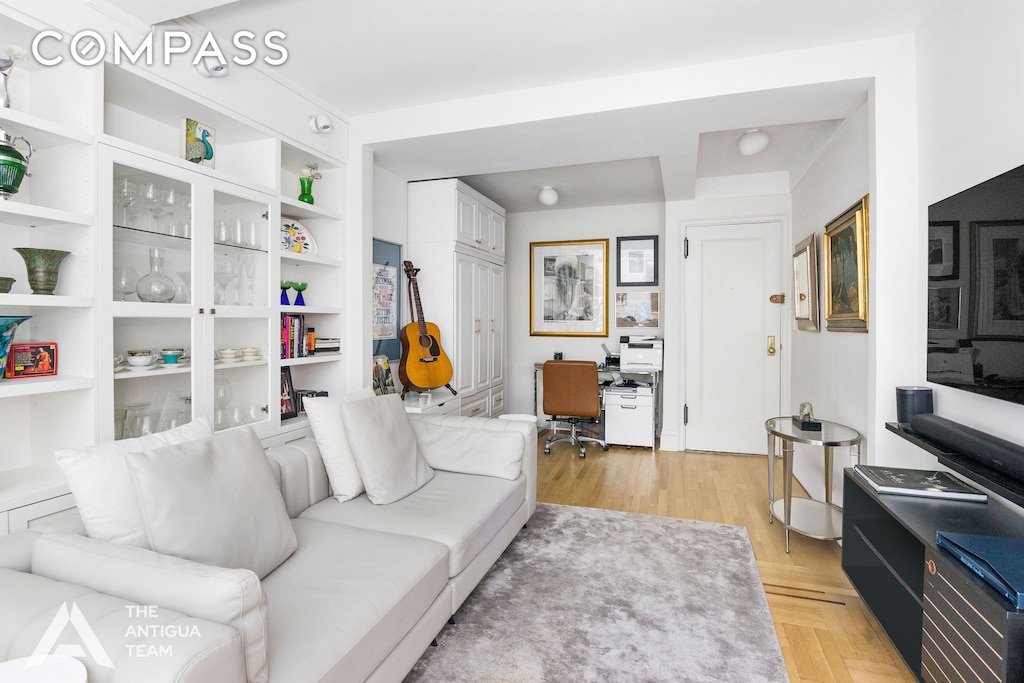 living area featuring parquet flooring