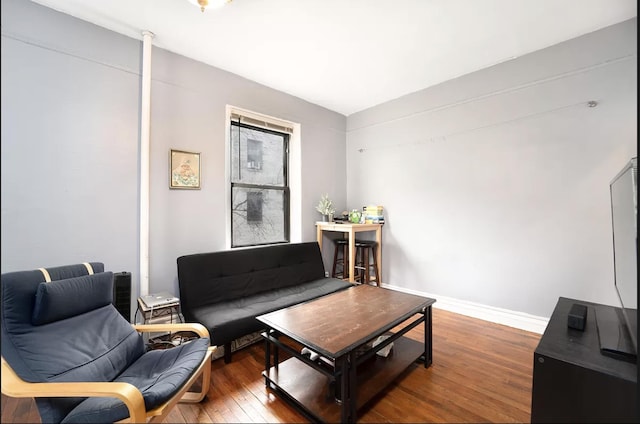 living room featuring baseboards and wood finished floors