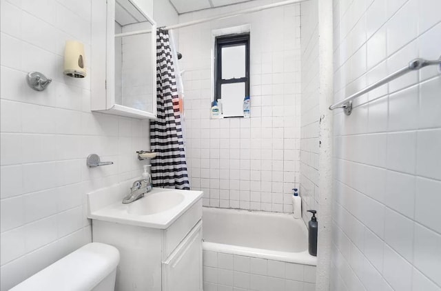 full bathroom with toilet, shower / bath combination with curtain, vanity, and tile walls