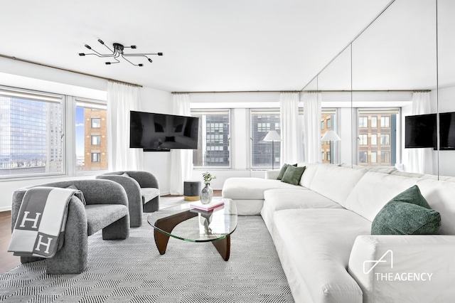 150 W 56th St Unit 5603, New York City, NY 10019 - living room featuring healthy amount of natural light and wood finished floors