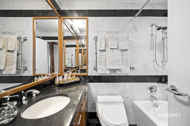 full bath featuring shower / bath combination, vanity, toilet, and tile walls