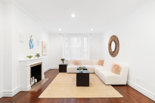 unfurnished living room with ornamental molding, recessed lighting, baseboards, and wood finished floors