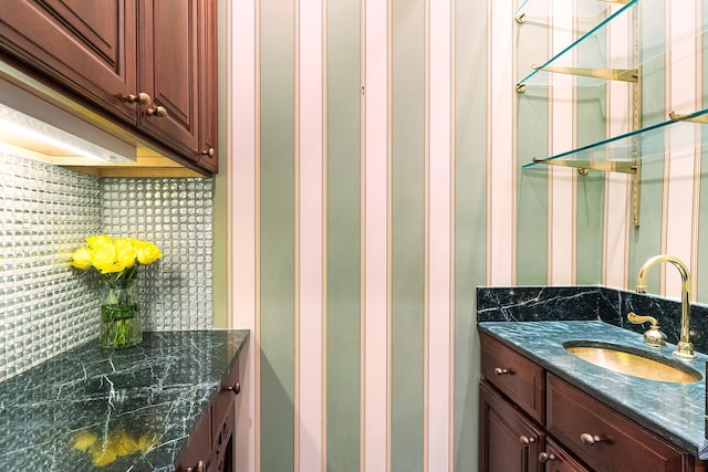 bathroom with decorative backsplash and vanity