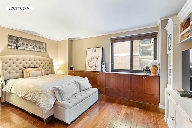 bedroom featuring visible vents, hardwood / wood-style floors, and ornamental molding