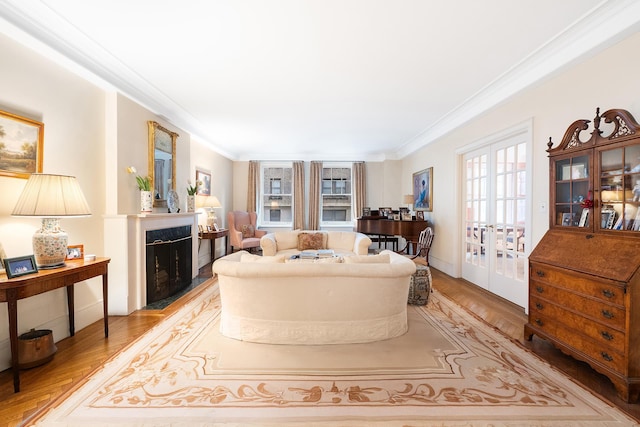 living area with crown molding, french doors, wood finished floors, and a fireplace with flush hearth