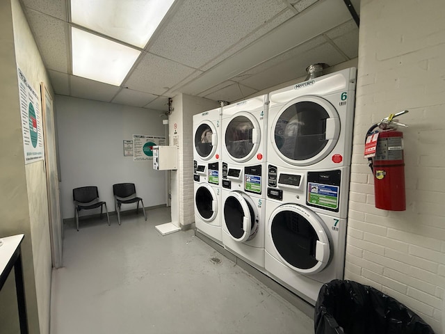 community laundry room with stacked washing maching and dryer