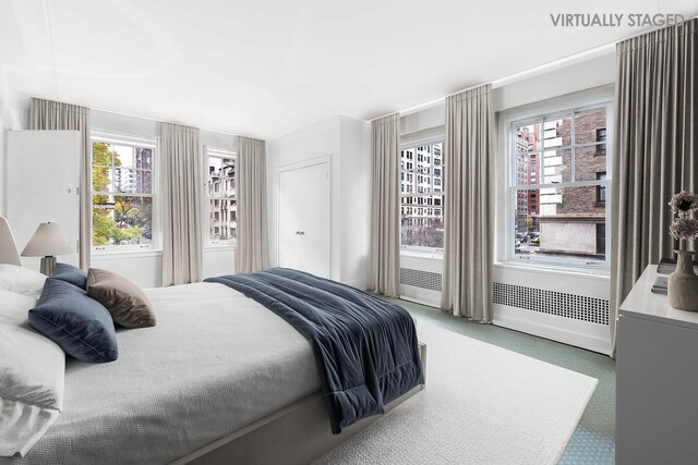 1075 Park Ave Unit 3D, New York City, NY 10128 - bedroom featuring light carpet and baseboards