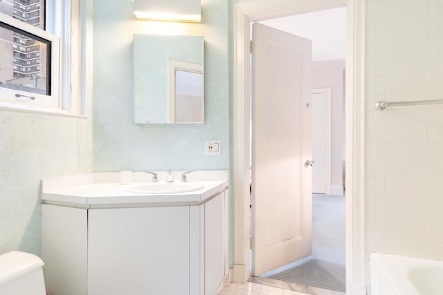bathroom featuring vanity, toilet, and tile patterned flooring