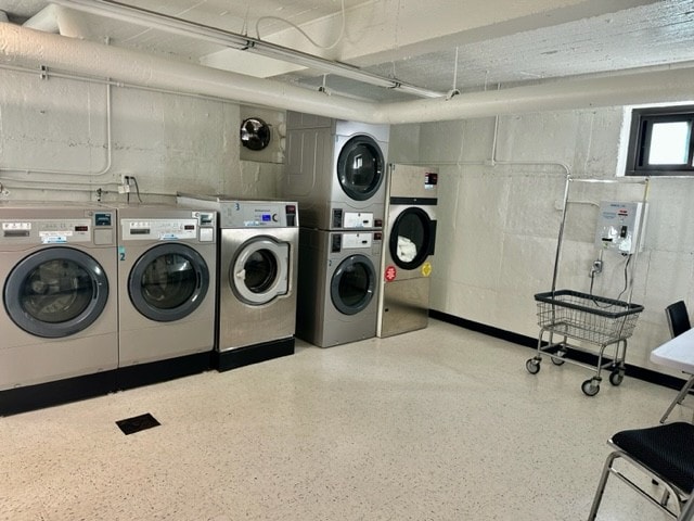 laundry room featuring stacked washer / dryer and washing machine and dryer