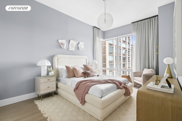 bedroom with hardwood / wood-style flooring