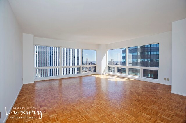 spare room with light parquet flooring