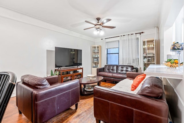 living area featuring a ceiling fan and wood finished floors