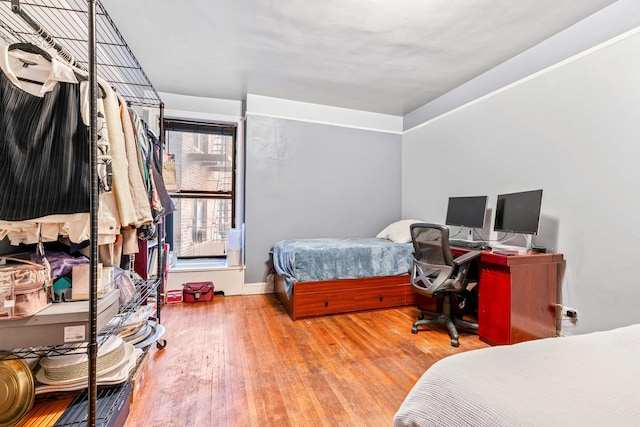 bedroom with wood finished floors and baseboards