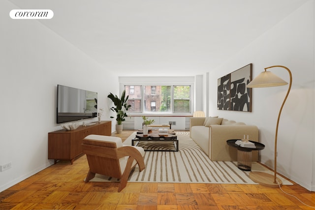 living area featuring baseboards