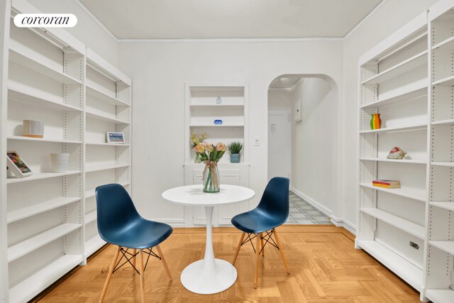 living room featuring parquet floors and crown molding