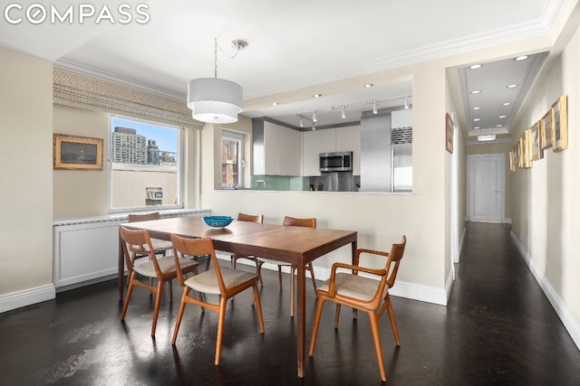 dining area featuring crown molding and rail lighting