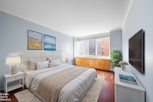 bedroom featuring hardwood / wood-style flooring and ornamental molding