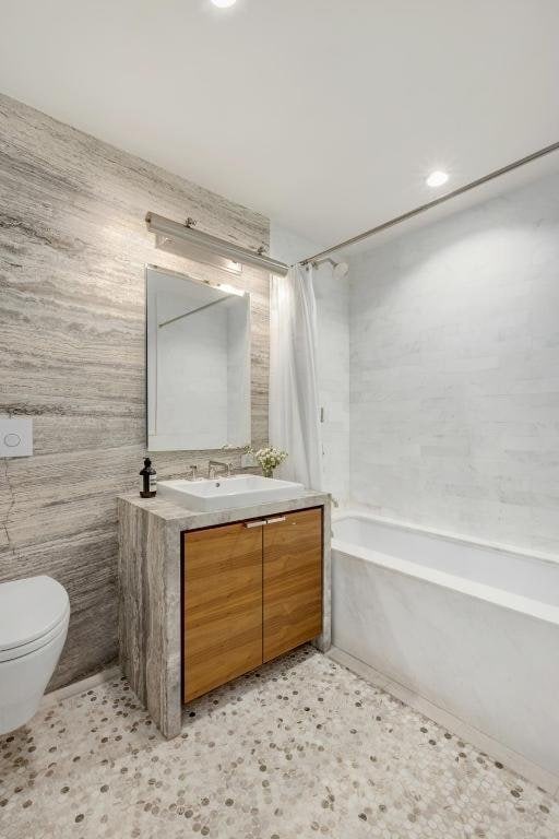 full bathroom with toilet, shower / bath combo, and vanity