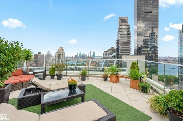 view of patio / terrace with a view of city, a balcony, and an outdoor hangout area