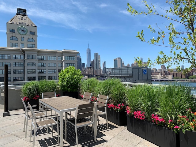 view of patio / terrace featuring a view of city and outdoor dining area