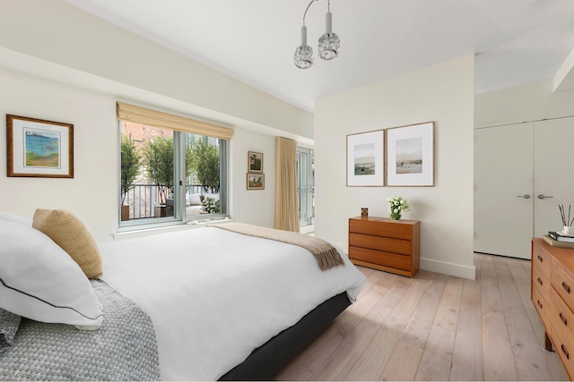 bedroom with light wood-type flooring and baseboards