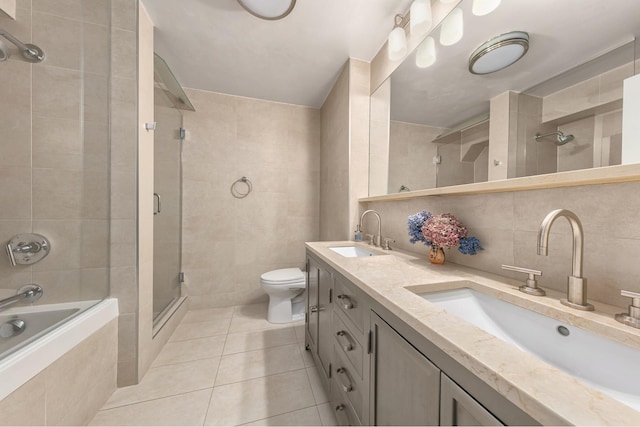 full bath with tile patterned flooring, a sink, and tile walls