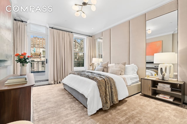 bedroom featuring a baseboard radiator, a notable chandelier, access to exterior, and ornamental molding