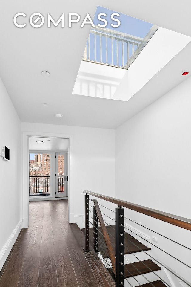 47 W 94th St, New York City, NY 10025 - hallway with an upstairs landing, wood finished floors, baseboards, and a skylight